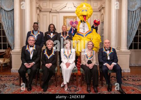 Die 2019 Kennedy Center Honors Preisträger posieren für ein Gruppenfoto auf das State Department in Washington, DC, 7. Dezember 2019. Vordere Reihe von links: Michael Tilson Thomas, Linda Ronstadt, Sally Field, Joan Ganz Cooney, und Lloyd Morrisett, hintere Reihe von links: Philip Bailey, Verdine White und Ralph Johnson und Sesamstraße Zeichen, Abby Cadabby, Big Bird, und Elmo. Stockfoto