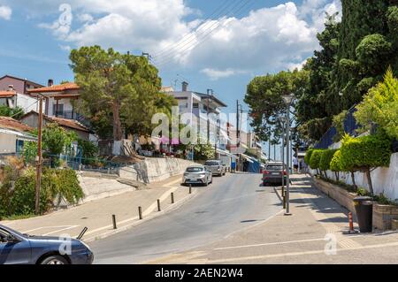 Gemütliche Ferienort umgeben von viel Grün und Blumen umgeben. Griechenland. Stadt am Meer Straße Stockfoto