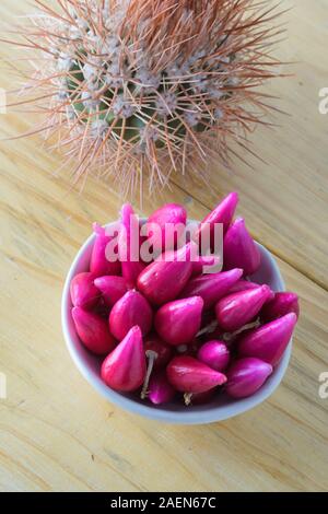 Pitiguey Obstgruppe in weißer Schale auf Holztisch mit Melocactus Stockfoto