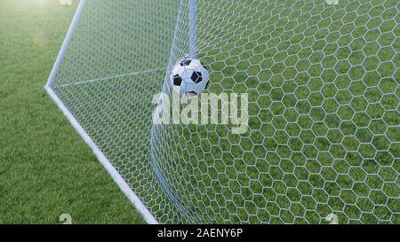 3D-Illustration Soccer Ball flog in das Ziel. Fußball beugt die Net, vor dem Hintergrund von Gras. Soccer Ball im Ziel net auf Gras Stockfoto