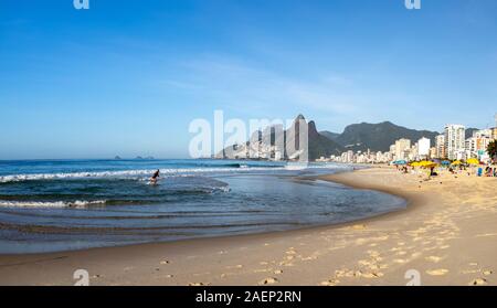 Panorama der frühen Morgen Ipanema Beach in Rio de Janeiro mit dem Ozean und Spuren am Strand im Vordergrund und die beiden Brüder Berg Stockfoto