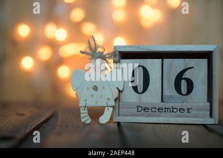 Cube Holz- Kalender mit Datum am 6. Dezember mit Angel über bokeh Hintergrund. Adventskalender, Weihnachten Hintergrund, Kopieren Raum Stockfoto