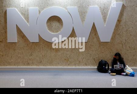 Madrid, Spanien. 10 Dez, 2019. Ein Besucher sitzen auf dem Boden eines Pavillons auf der UN-Klimakonferenz in Madrid. Credit: Clara Margais/dpa/Alamy leben Nachrichten Stockfoto