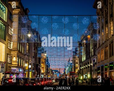 Weihnachtsbeleuchtung in der Oxford Street, London mit Käufern. Stockfoto