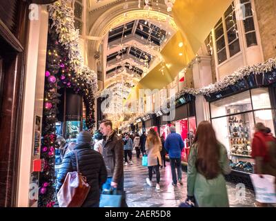Weihnachten LONDON BURLINGTON ARCADE 2019 festliche Fenster anzeigen CHRISTMAS SHOPPING Einkaufen Innenraum charmante Olde Worlde Burlington Arcade in seinen 200 Jahr im Piccadilly mit traditionellen Weihnachtsschmuck funkelnden Lichtern und Massen von Käufern in eine up-market shopping Umwelt London UK Stockfoto
