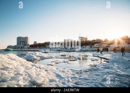 Odessa, Ukraine - Februar, 16 2017: eine gefrorene Küste des Schwarzen Meeres mit Eis bei Sonnenuntergang abgedeckt in der Mitte der Stadt Odessa, Arcadia Strand Stockfoto
