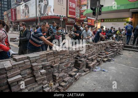 In Mong Kok, Tin Shui Wai und Sai Wan Ho, drei Bereiche, die die Hauptlast der rampages Randalierer in den letzten Tagen trug, Bewohner hoben Steine und Müll le Stockfoto