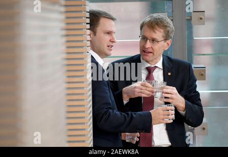 Kiel, Deutschland. 11 Dez, 2019. Daniel Günther (CDU, r), Ministerpräsident von Schleswig-Holstein, und Christopher Vogt, Vorsitzender der FDP-Bundestagsfraktion, sprechen miteinander während der Sitzung des Landtages. Der schleswig-holsteinische Landtag will den Haushalt 2020 zu übertragen. Credit: Carsten Rehder/dpa/Alamy leben Nachrichten Stockfoto