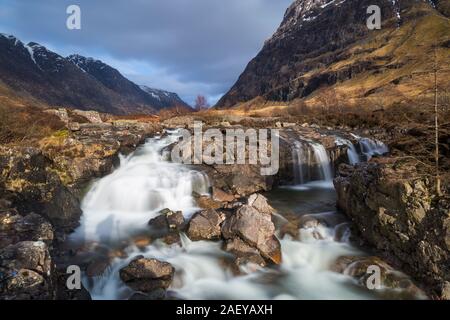 Clachaig fällt mit dem Aonach Dubh in der Ferne Glencoe, Scottish Highlands, Schottland, UK im März - lange Belichtung Stockfoto