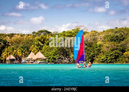 Ein Segelboot auf dem See von sieben Blues' in Bacalar, Quintana Roo, Mexiko. Stockfoto