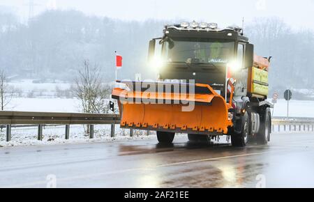 Ebensfeld, Deutschland. 12 Dez, 2019. Ein Fahrzeug der Winter clearing service fährt auf einer Landstraße. Der erste Schnee in Franken ist hier. Credit: Nicolas Armer/dpa/Alamy leben Nachrichten Stockfoto