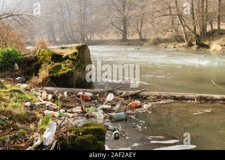 Baile Tusnad, Rumänien - 28.November 2019: Umweltverschmutzung. Kunststoff, Glas und Metall in der olt River in Baile Tusnad, Siebenbürgen, Romani Stockfoto