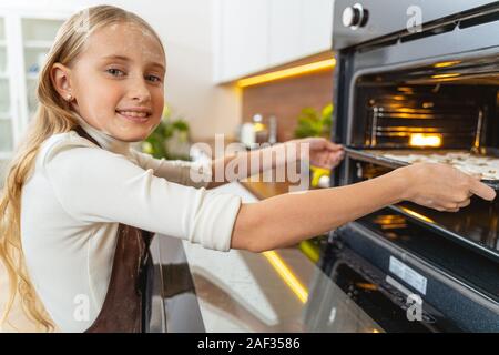 Hübsches Mädchen stehen in der Nähe von offenen Ofen Stockfoto