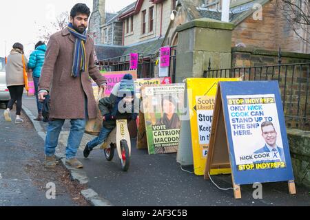 Edinburgh, Schottland, 12. Dezember 2019. Ein Vater hat seine Stimme für einen Kandidaten im Winter Allgemein der britischen Wahlen werfen. Sein junger Sohn ist nicht interessiert. Credit: Brian Wilson/Alamy Leben Nachrichten. Stockfoto