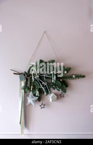 Weihnachtsdekoration mit tannenzweigen an der Wand Stockfoto