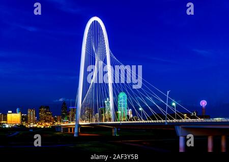 Dallas, Texas die Skyline in der Dämmerung, mit Margaret Hunt Hill Brücke im Vordergrund. Stockfoto