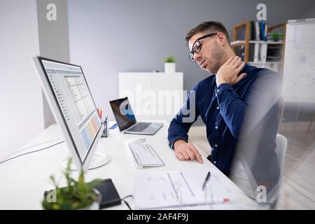 Portrait der Junge Unternehmer leiden unter Nackenschmerzen Stockfoto