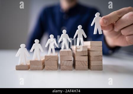 Unternehmer die menschliche Figur auf den Holzblock Stockfoto