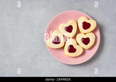 Valentine Cookies in einem rosa Platte auf hellen Hintergrund Stockfoto