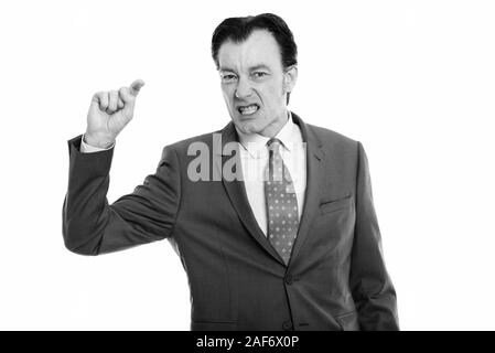 Studio shot reifer Geschäftsmann auf der Suche wütend, während der Zeigefinger Stockfoto