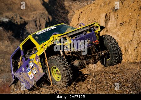 Jeep Suzuki Jimny überwindet Hindernisse in den Wald Stockfoto