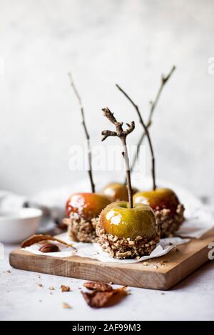 Toffee Äpfel getaucht In zerquetscht Pekannüsse Stockfoto