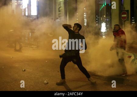 Beirut, Libanon. 14 Dez, 2019. Eine Demonstrantin shouts Parolen bei Zusammenstößen mit libanesischen Bereitschaftspolizei in der Nähe der libanesischen Parlament Gebäude. Credit: Marwan Naamani/dpa/Alamy leben Nachrichten Stockfoto