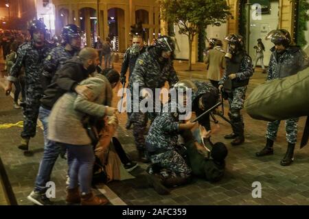 Beirut, Libanon. 14 Dez, 2019. Libanesische Polizisten verhaften ein Demonstrant bei Zusammenstößen in der Nähe der libanesischen Parlament Gebäude. Credit: Marwan Naamani/dpa/Alamy leben Nachrichten Stockfoto