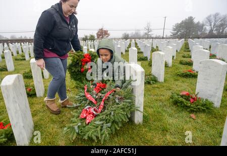 Newtown, United States. 14 Dez, 2019. Bretagne Wismer von Edison und ihr Sohn Ayden Wismer, 5, besuchen Sie das Grab von der Bretagne Vater während Kränze über Amerika Samstag, 14. Dezember 2019 in Washington Crossing National Cemetery in Newtown, Pennsylvania. Tausende von Kränze werden jedes Jahr für Kränze über Amerika von Freiwilligen, die sammeln und dann die Kränze an den Gräbern der Veteranen getroffen werden. (Credit: William Thomas Kain/Alamy leben Nachrichten Stockfoto