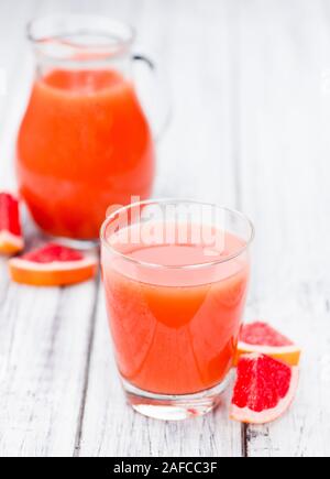 Vintage Holztisch mit einer Portion frisch gepressten Grapefruitsaft (selektive Fokus) Stockfoto