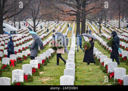 Arlington, Vereinigten Staaten von Amerika. 14. Dezember, 2019. Freiwillige tragen Kränze auf Grabstätten der Gefallenen service Mitglieder während der 28 Kränze über Amerika Tag auf dem Arlington National Cemetery Dezember 14, 2019 in Arlington, Virginia. Mehr als 38.000 Freiwilligen statt Kränze auf jeder Grabstätte auf dem Arlington National Cemetery und anderen Seiten rund um die Nation. Credit: Elizabeth Fraser/DOD/Alamy leben Nachrichten Stockfoto