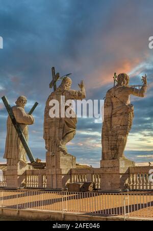 Statuen von Christus, Johannes der Täufer und ein Apostel auf der Oberseite der St. Peter Basilika Fassade. Stockfoto