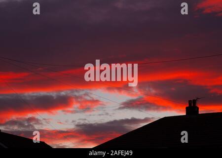 Feurigen Sonnenuntergang über Honley Dächer Stockfoto