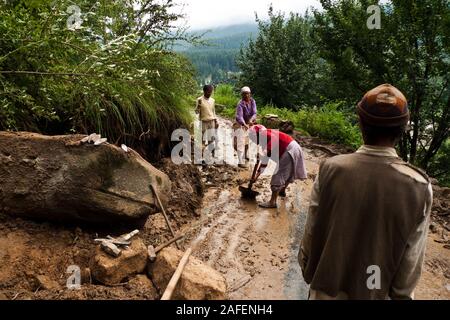 Vashisht, Himachal Pradesh, Indien: Zwei Frauen schaufel Schlamm von eine straße Stockfoto