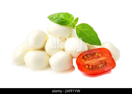 Haufen mini Mozzarella Kugeln, Basilikum und die Hälfte der Cherry Tomaten auf weißem Hintergrund. Healhy mediterrane Küche und vegetarische Kost. Stockfoto