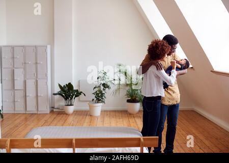 Liebevolle Eltern mit neugeborenen Babys zu Hause in Loft Apartment Stockfoto