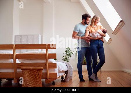 Liebevolle Eltern mit neugeborenen Babys zu Hause in Loft Apartment Stockfoto