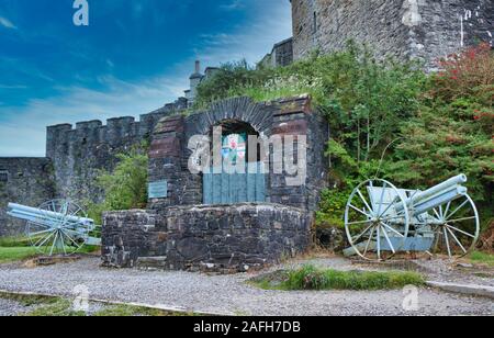 Bronzeplakette mit Namen von Mitgliedern des Clan MacRae, der im ersten Weltkrieg getötet wurde und von 2 deutschen Feldgewehren, Eilean Donan Castle, Schottland, flankiert wird Stockfoto