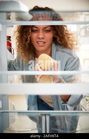 Enttäuscht, Frau auf der Suche nach innen Kühlschrank leer Außer Kartoffel im Regal Stockfoto