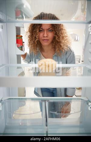 Enttäuscht, Frau auf der Suche nach innen Kühlschrank leer Außer Kartoffel im Regal Stockfoto