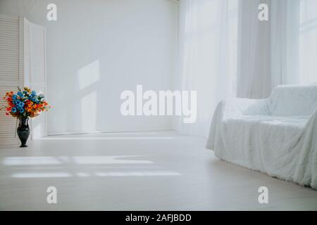 Home Decor weiße Zimmer mit Sofa und Blumen in einer Vase Stockfoto