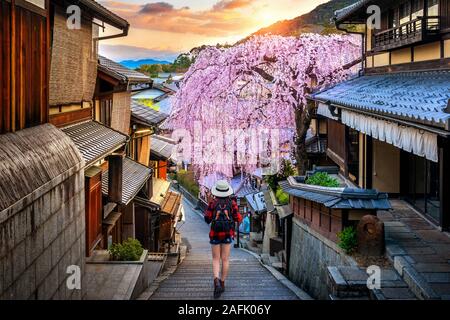 Frau Reisenden mit Rucksack zu Fuß an der historischen Higashiyama Bezirk im Frühjahr, Kyoto in Japan. Stockfoto