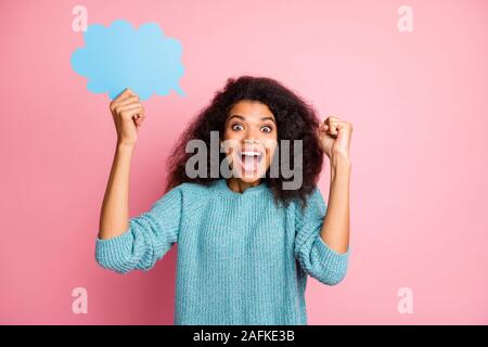 Foto von modischen braunen Haare lockig Wellig trendigen fröhlichen Casual woman holding Blase mit Copyspace Ausdruck von Emotionen im Gesicht blau isoliert Stockfoto