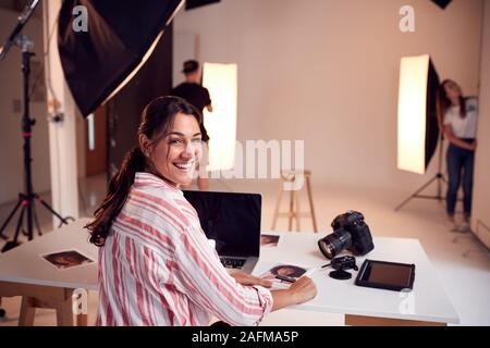 Portrait von professionellen Fotografin arbeiten im Studio mit Assistenten Stockfoto