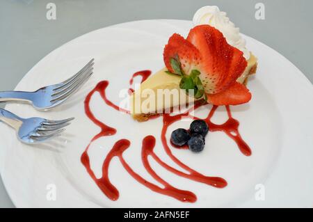 Key Lime Pie auf Platte, garniert mit Erdbeeren, Blaubeeren, Schlagsahne, im Restaurant in touristischen Ort in tropischen Key West, Florida, USA Stockfoto