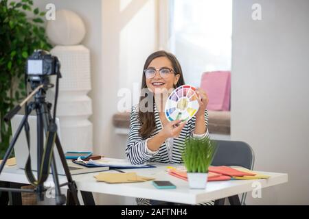 Freudige gut aussehende Frau spricht auf der Kamera Stockfoto