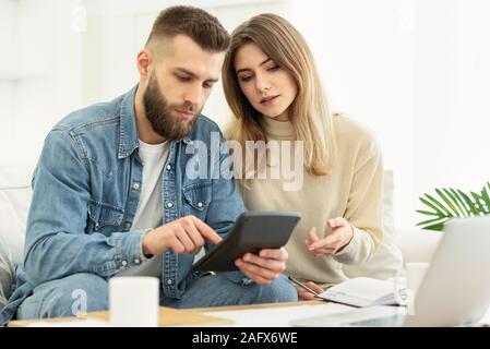 Ernsthafte paar Prüfung der Buchhaltung und der Berechnung der Rechnungen Stockfoto