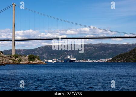 Kreuzfahrtschiff Marella Explorer Auslaufen aus dem Hafen von Bergen, Norwegen. Anfahren der Askoey Suspension Bridge. Sandviken im Hintergrund. Stockfoto