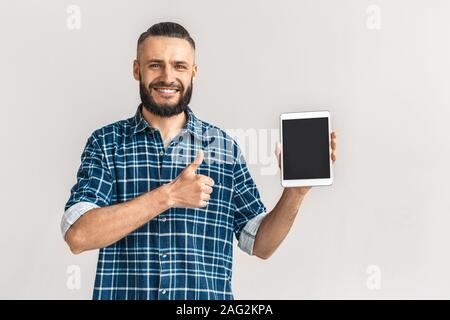 Nach bärtigen Mann Daumen nach oben zeigt und Tablet-PC Stockfoto