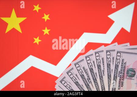 Flagge von China mit einem nach oben zeigenden Pfeil auf einem Hintergrund und Dollarscheine. Konzept Foto für Wirtschaftswachstum in China. Stockfoto